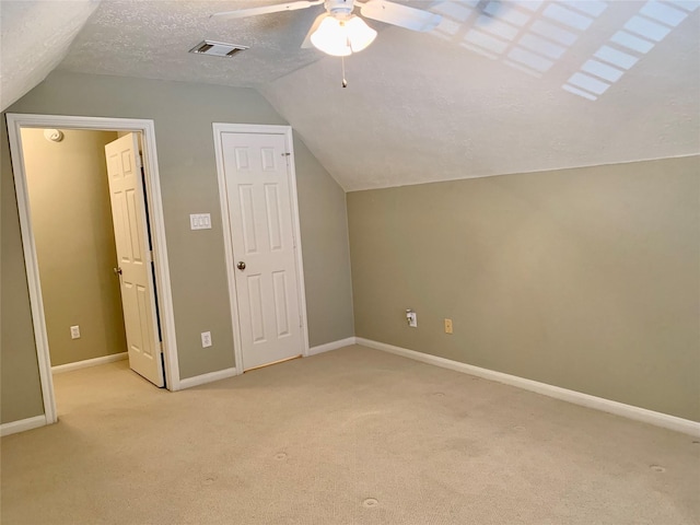 bonus room with a textured ceiling, light carpet, ceiling fan, and vaulted ceiling