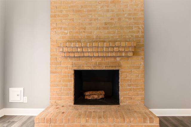 interior details with a fireplace and wood-type flooring