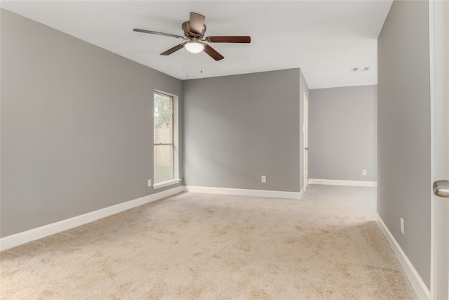 carpeted spare room with ceiling fan