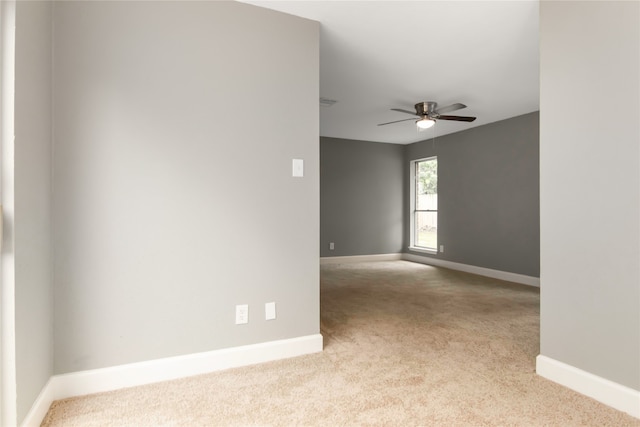 unfurnished room with ceiling fan and light colored carpet