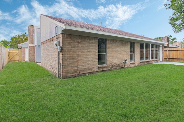 back of property featuring a lawn