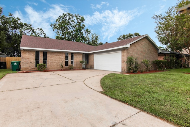 single story home featuring a garage and a front yard