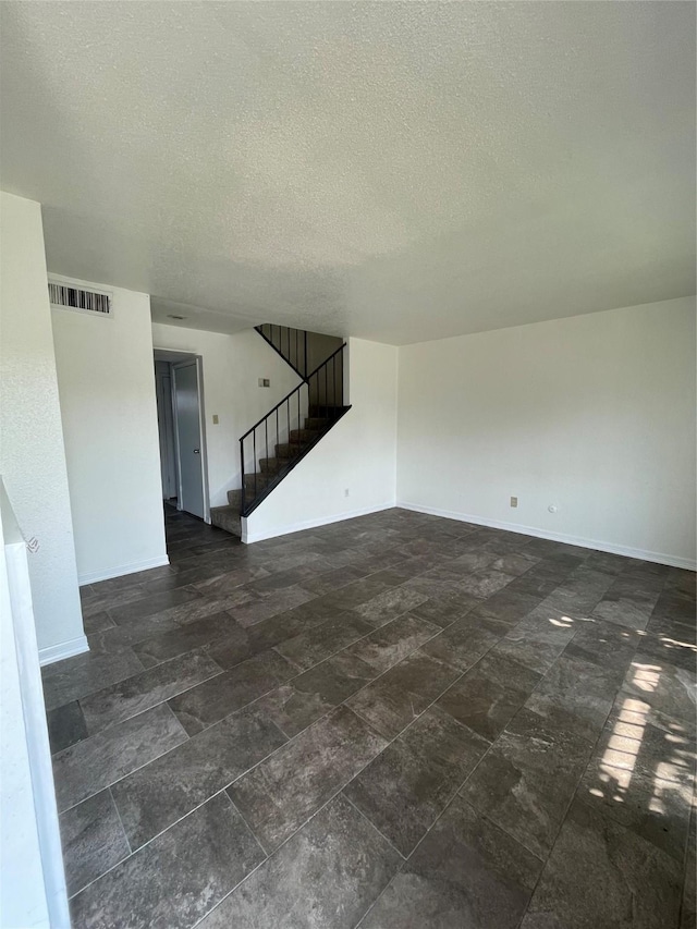 spare room featuring a textured ceiling