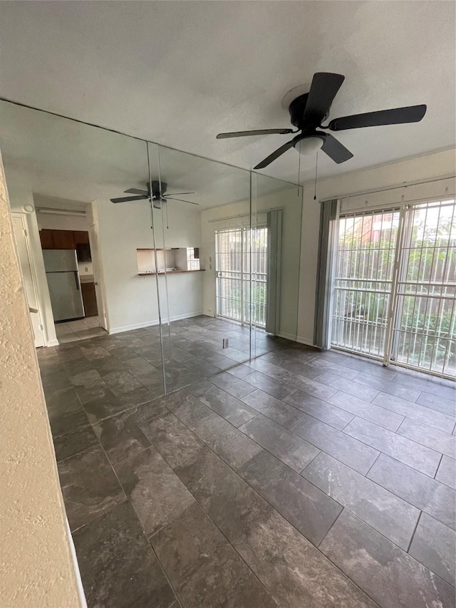 unfurnished room featuring ceiling fan