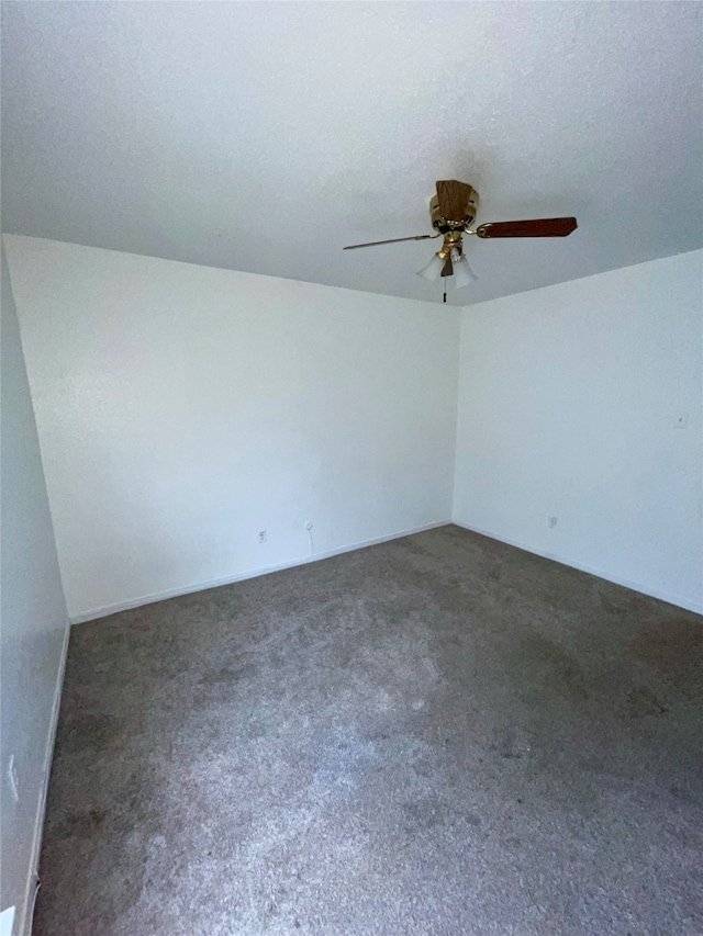 carpeted spare room featuring a textured ceiling and ceiling fan