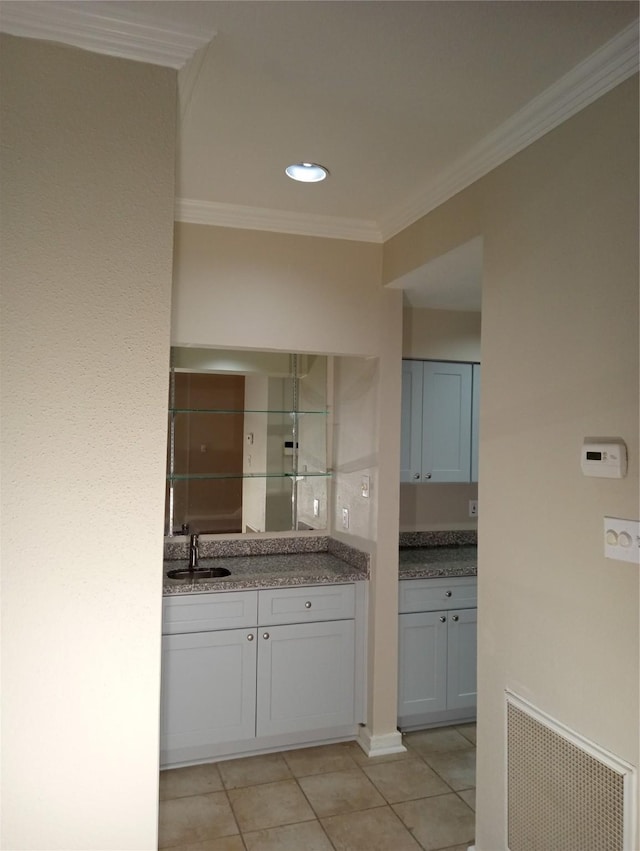 bathroom with ornamental molding, vanity, and tile patterned floors