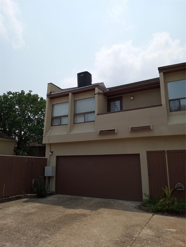 view of front of property with cooling unit and a garage