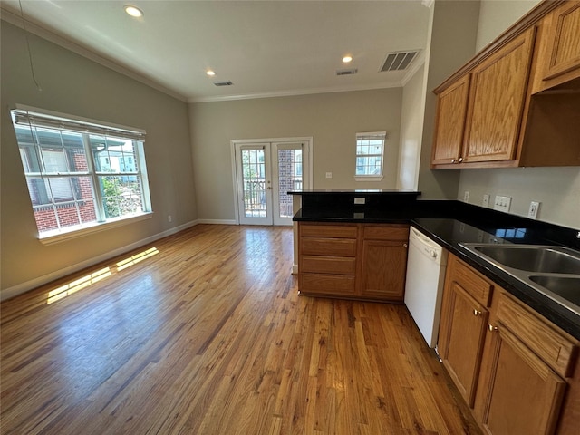 kitchen with dishwasher, kitchen peninsula, light hardwood / wood-style flooring, and crown molding