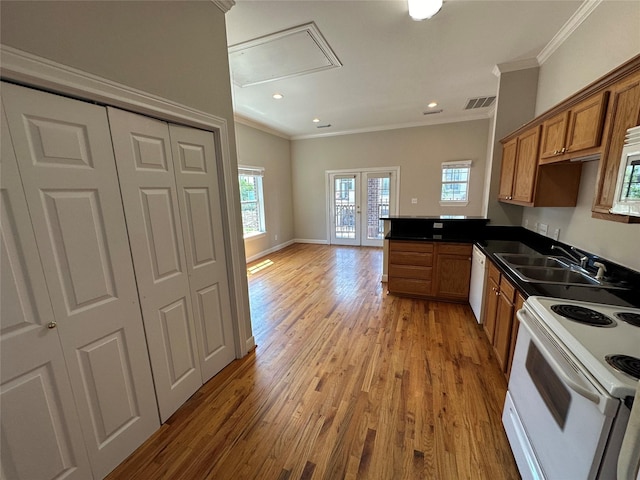 kitchen featuring french doors, white appliances, crown molding, sink, and hardwood / wood-style flooring