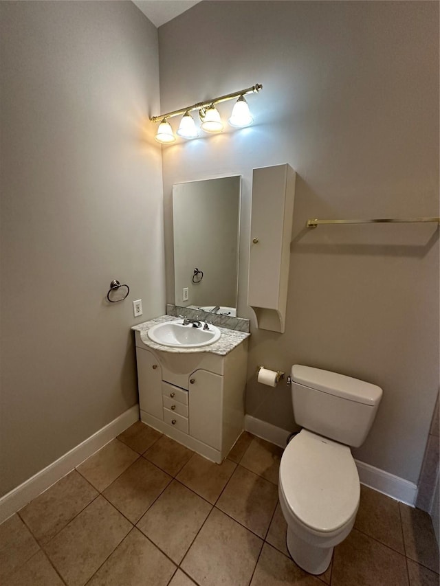 bathroom with tile patterned flooring, vanity, and toilet