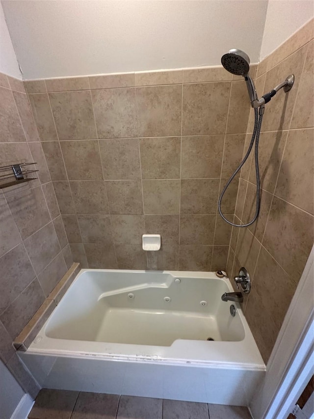 bathroom with tiled shower / bath combo and tile patterned floors