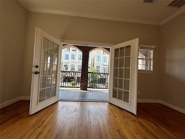 doorway to outside with crown molding, french doors, and hardwood / wood-style floors