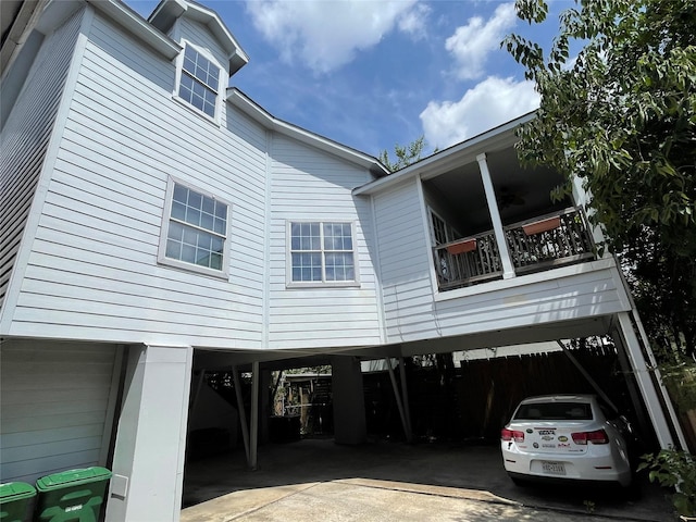 view of home's exterior with a balcony and a carport