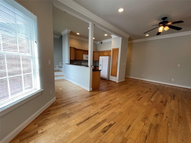 unfurnished living room with ceiling fan, light hardwood / wood-style floors, and ornamental molding