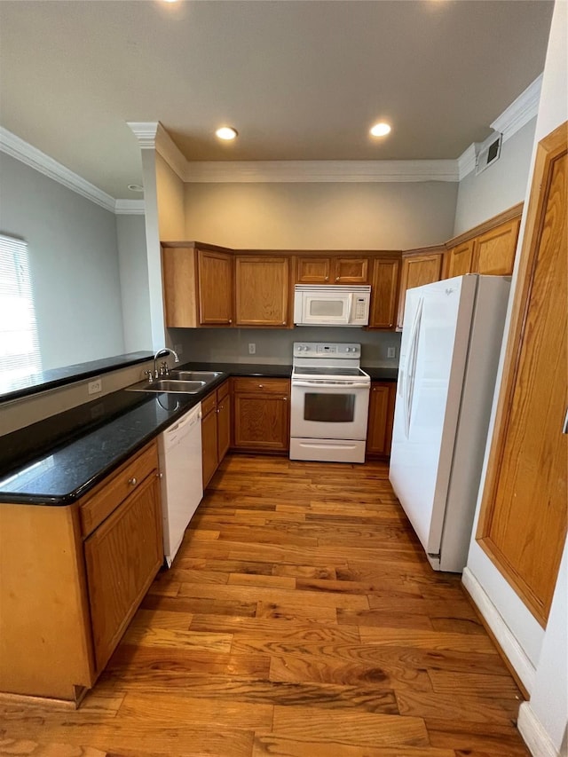 kitchen featuring sink, kitchen peninsula, crown molding, white appliances, and light wood-type flooring