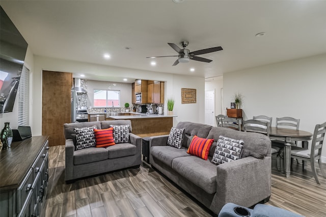 living room with sink, ceiling fan, and hardwood / wood-style floors