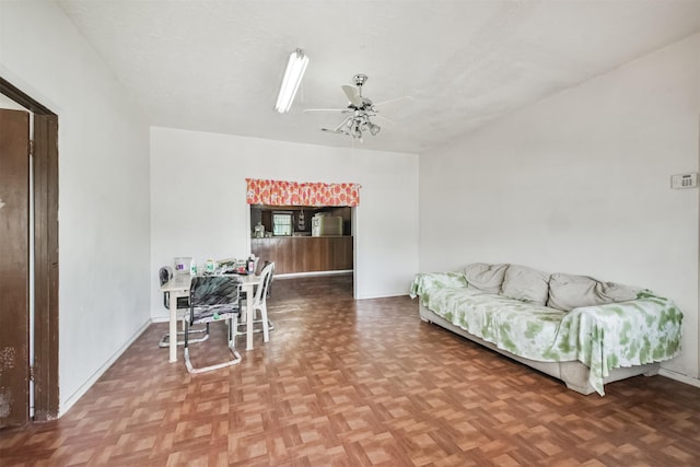 living room featuring ceiling fan and parquet floors