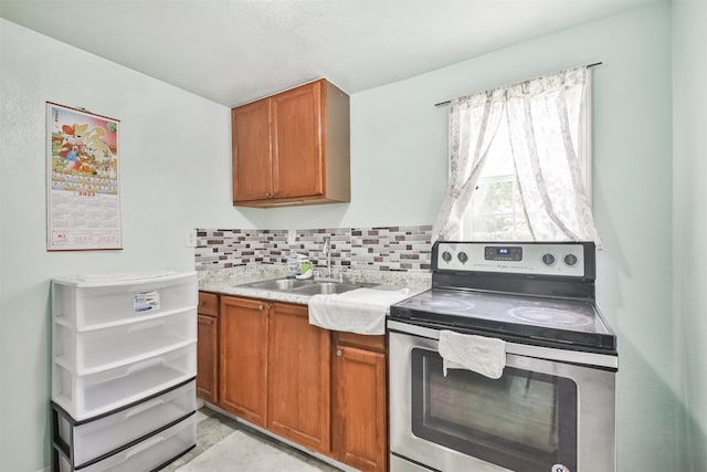 kitchen with sink, backsplash, and electric stove