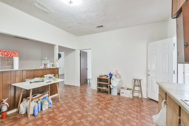 interior space featuring light parquet flooring and a textured ceiling