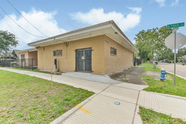 view of side of home with a yard