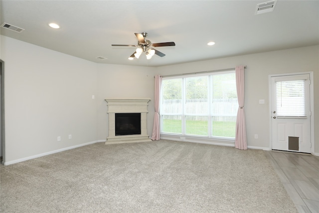 unfurnished living room with light carpet and ceiling fan