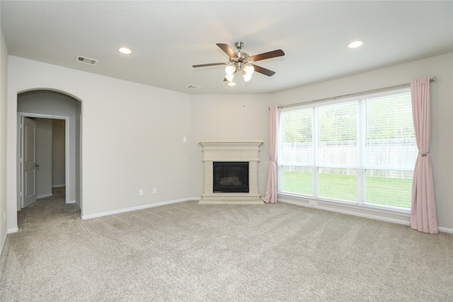 unfurnished living room with light carpet and ceiling fan