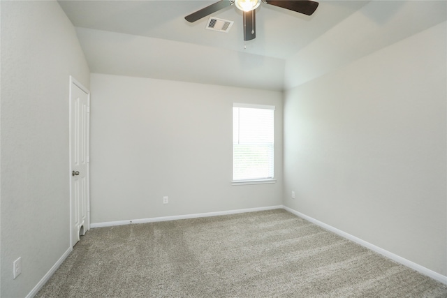 carpeted empty room with vaulted ceiling and ceiling fan