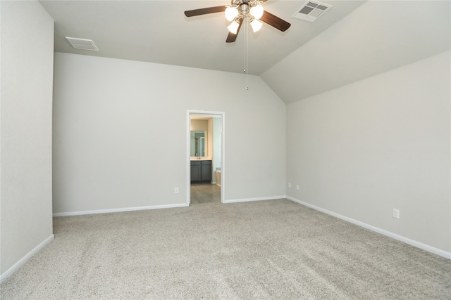 empty room featuring light carpet, lofted ceiling, and ceiling fan