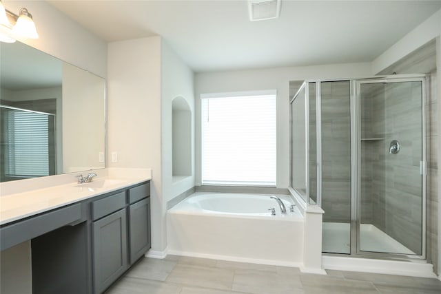 bathroom featuring vanity, tile patterned flooring, and plus walk in shower