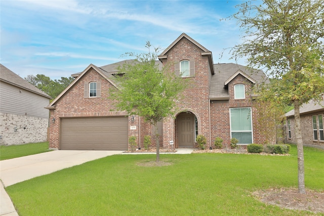 view of front of property featuring a garage and a front lawn