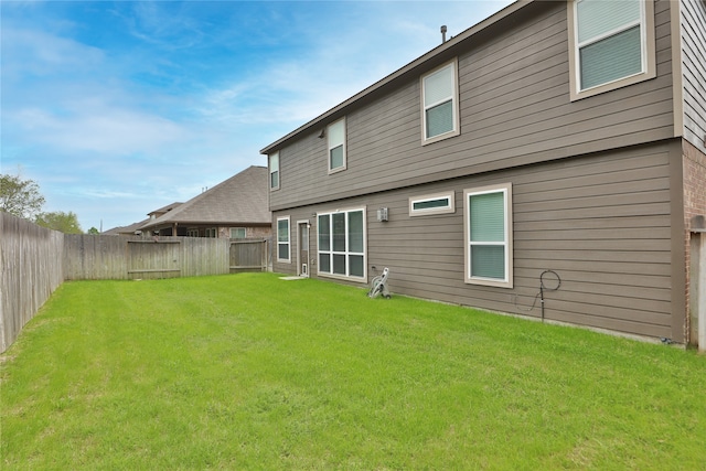 rear view of house featuring a lawn