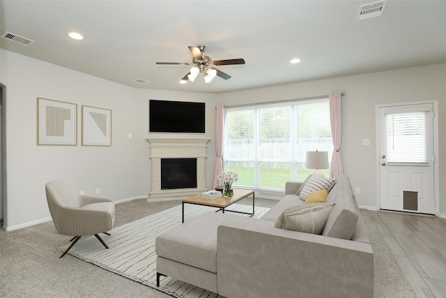 living room featuring light colored carpet and ceiling fan