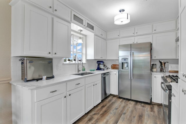 kitchen with sink, white cabinets, dark hardwood / wood-style flooring, and appliances with stainless steel finishes