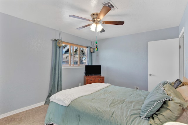 bedroom with ceiling fan and light colored carpet