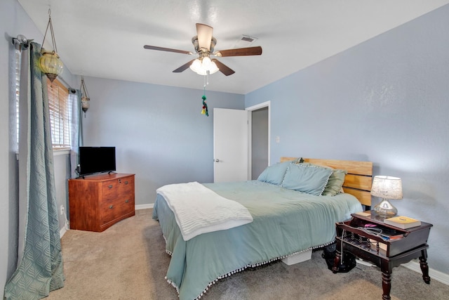 bedroom with ceiling fan and light carpet