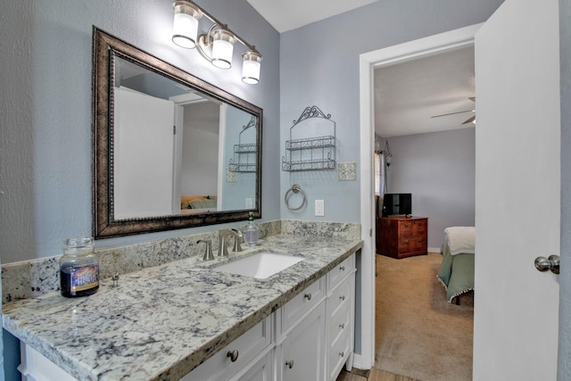 bathroom featuring ceiling fan and vanity