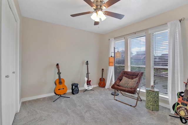 sitting room featuring ceiling fan and light carpet