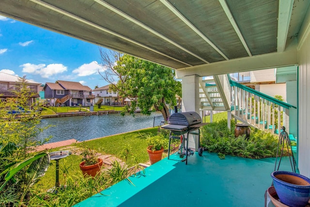 view of patio featuring a water view and grilling area