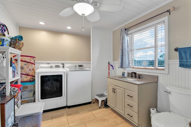 washroom featuring washer and clothes dryer, sink, ornamental molding, ceiling fan, and light tile patterned floors