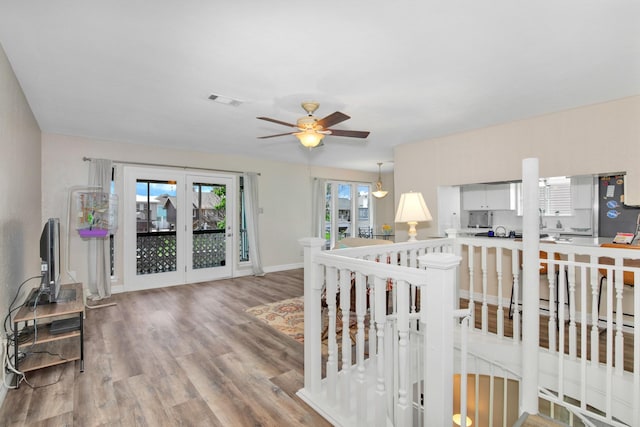 living room with light wood-type flooring and ceiling fan