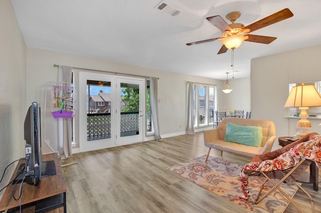 living area featuring ceiling fan and wood-type flooring