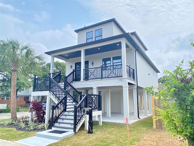 raised beach house with a porch and a front lawn