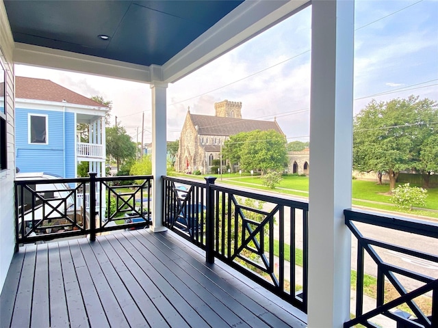 wooden terrace featuring covered porch