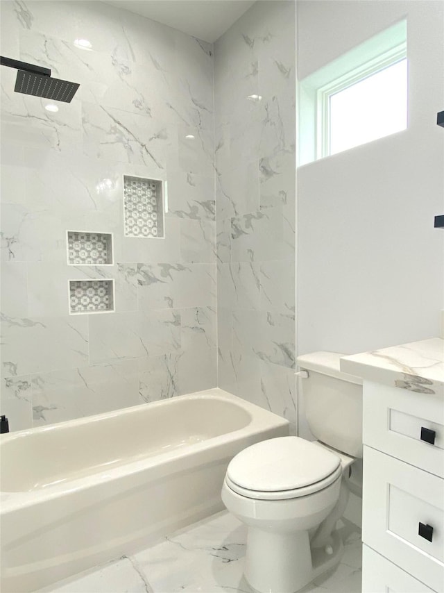 bathroom featuring tiled shower / bath combo and toilet