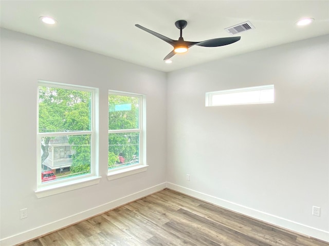 spare room with light hardwood / wood-style floors and ceiling fan