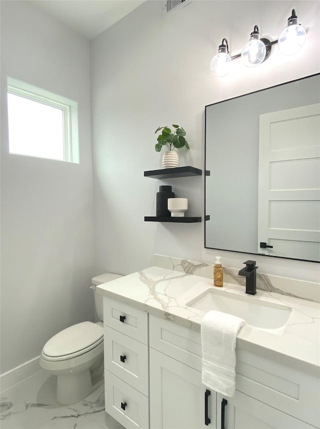 bathroom with vanity and toilet