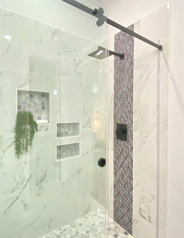 bathroom featuring a shower with door