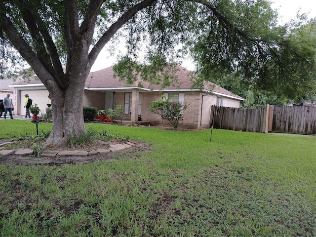 view of front of house with a front yard and a garage