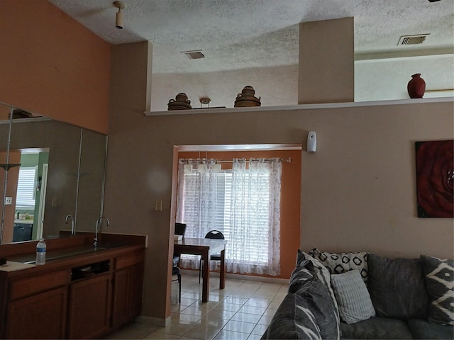 living room featuring light tile patterned floors and a textured ceiling