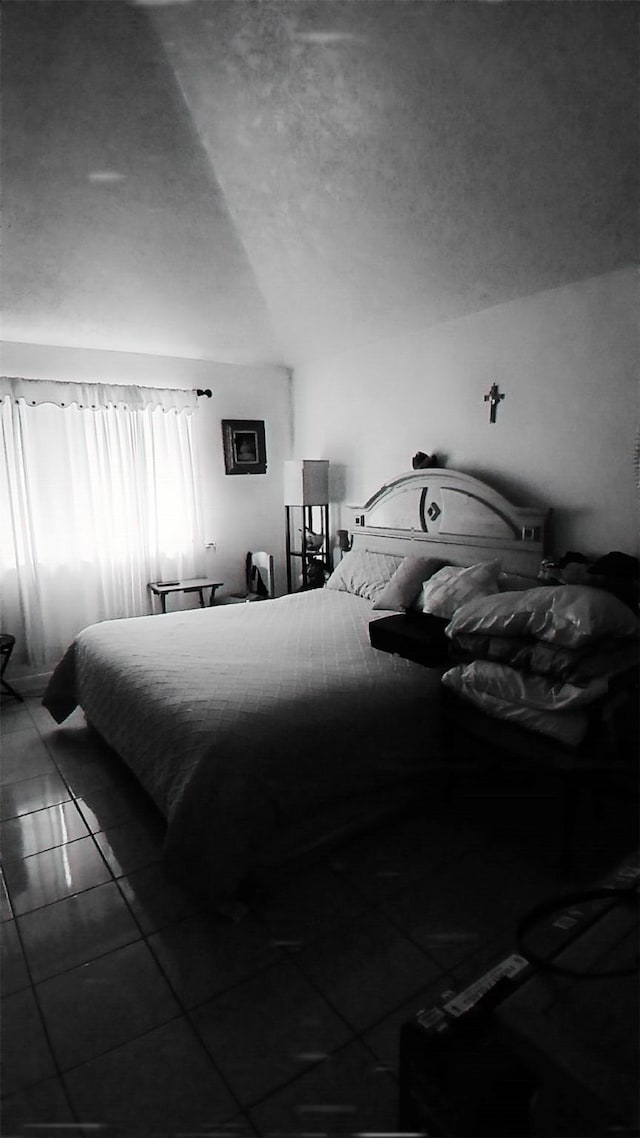 tiled bedroom with a textured ceiling